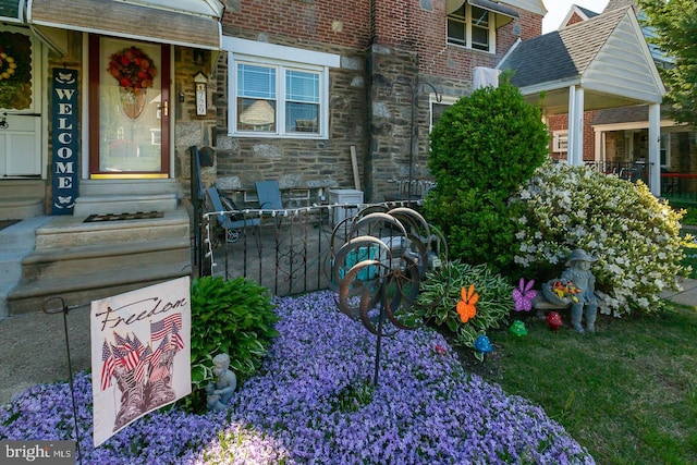 property entrance featuring brick siding and stone siding