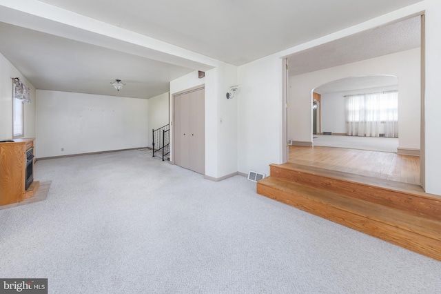 161 E Ave, Woodstown, NJ 08098 - unfurnished living room featuring arched walkways, baseboards, and stairs