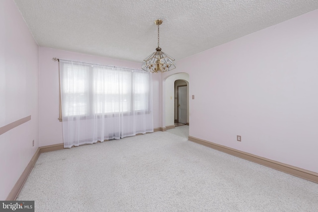 161 E Ave, Woodstown, NJ 08098 - unfurnished room with arched walkways, a textured ceiling, a chandelier, baseboards, and carpet floors