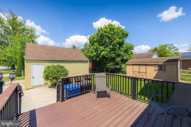 161 E Ave, Woodstown, NJ 08098 - wooden terrace featuring an outdoor structure, a lawn, and a storage shed