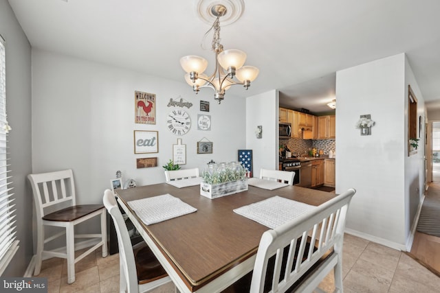 dining space with baseboards, a notable chandelier, and light tile patterned floors