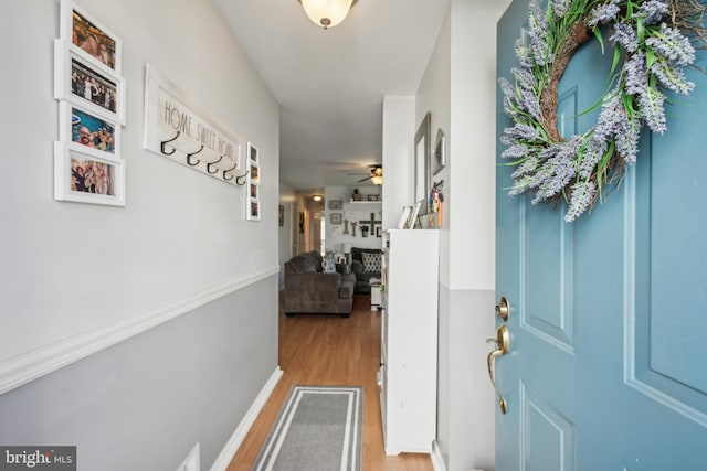 interior space with baseboards and light wood-style floors