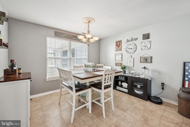 dining room featuring baseboards and a notable chandelier