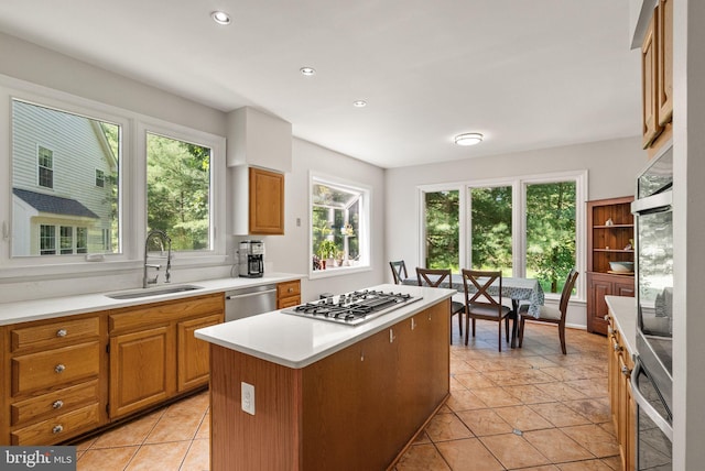 20665 Shoal Pl, Sterling, VA 20165 - kitchen with stainless steel appliances, a kitchen island, light countertops, recessed lighting, and light tile patterned flooring