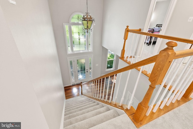 20665 Shoal Pl, Sterling, VA 20165 - stairs featuring a chandelier, a towering ceiling, and wood finished floors