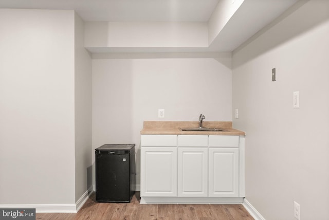 20665 Shoal Pl, Sterling, VA 20165 - bar featuring a sink and light wood-style flooring