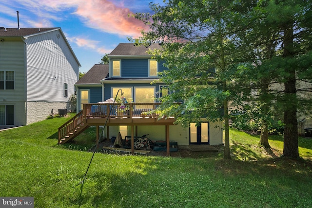 20665 Shoal Pl, Sterling, VA 20165 - back of house at dusk with a deck, a yard, stairway, and roof with shingles