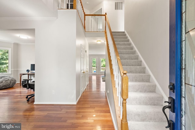20665 Shoal Pl, Sterling, VA 20165 - foyer featuring hardwood / wood-style floors, stairs, ornamental molding, and a towering ceiling