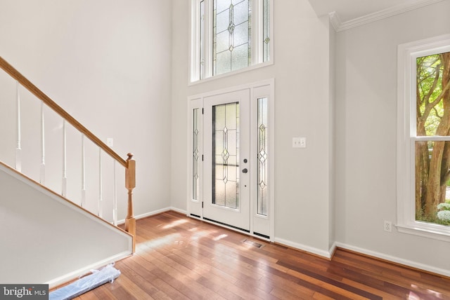 20665 Shoal Pl, Sterling, VA 20165 - foyer entrance with wood-type flooring, stairway, ornamental molding, and a high ceiling