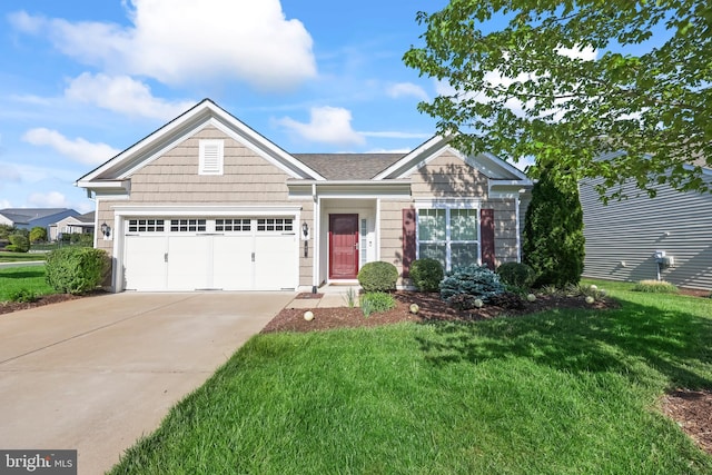 view of front of home with a garage, a front lawn, and concrete driveway