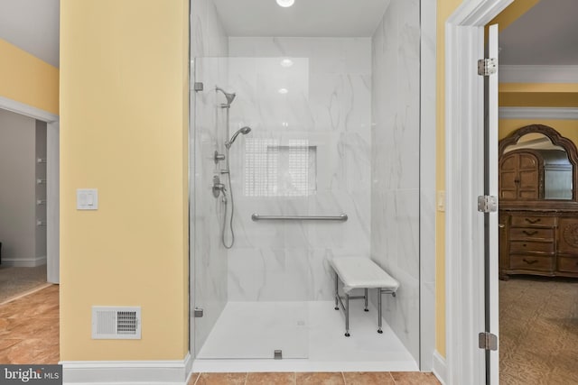 bathroom with visible vents and a marble finish shower