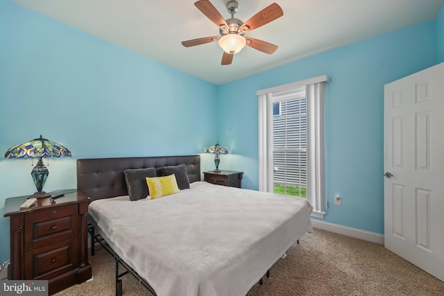 bedroom with baseboards, ceiling fan, and light carpet