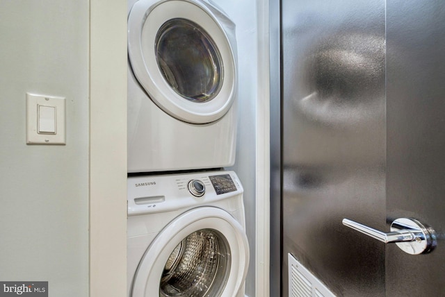 washroom featuring stacked washer / dryer