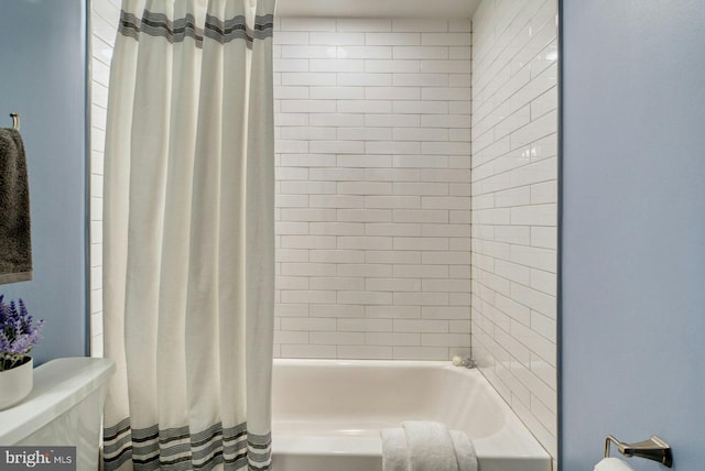 bathroom with toilet and shower / bath combo
