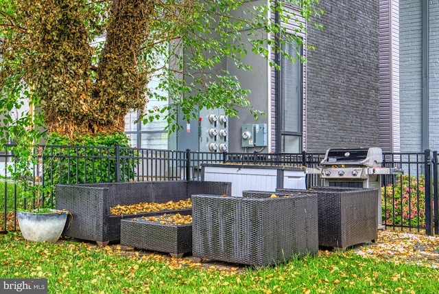 view of patio / terrace with fence and a grill