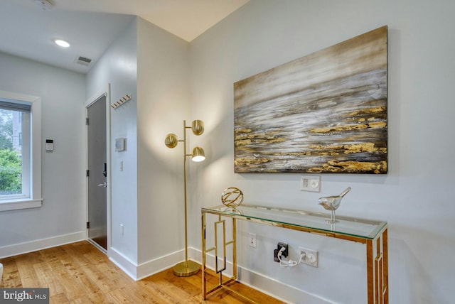 hallway with wood finished floors and baseboards