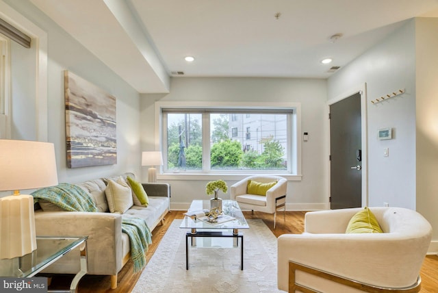 living room featuring wood finished floors, baseboards, and recessed lighting