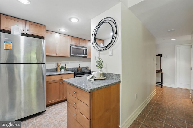 kitchen with appliances with stainless steel finishes, recessed lighting, and light tile patterned flooring
