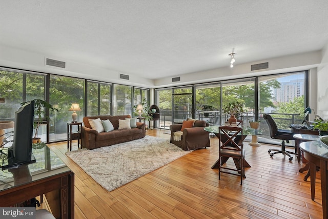 sunroom / solarium featuring visible vents and wood finished floors