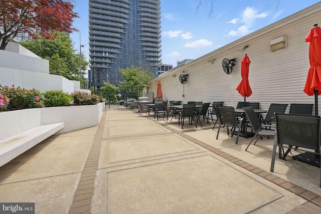 view of patio with fence and outdoor dining space