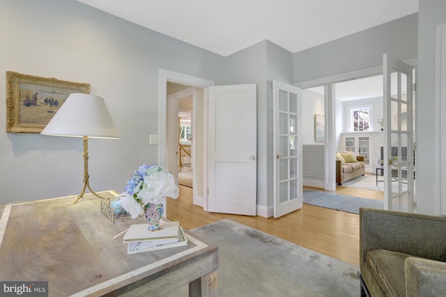 living area featuring french doors and wood finished floors