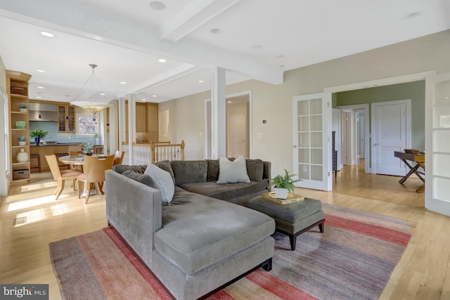 living room featuring recessed lighting, beam ceiling, and light wood-style floors