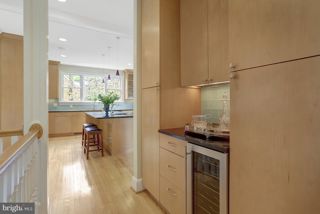 bar with backsplash, light wood-type flooring, a bar, wine cooler, and recessed lighting