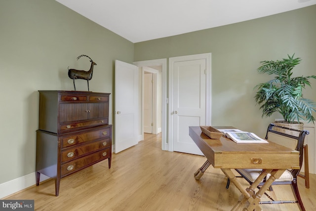 home office with baseboards and light wood-style floors