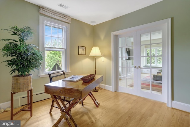 office space featuring light wood-style floors, baseboards, french doors, and visible vents