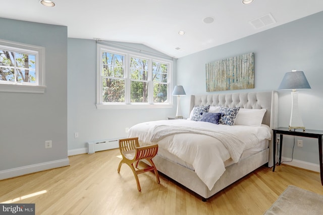 bedroom with visible vents, lofted ceiling, wood finished floors, recessed lighting, and a baseboard radiator