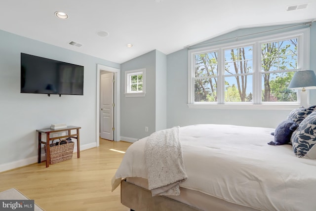 bedroom with recessed lighting, visible vents, lofted ceiling, and light wood-style floors