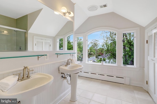 bathroom featuring tile patterned flooring, visible vents, a baseboard heating unit, a sink, and a stall shower