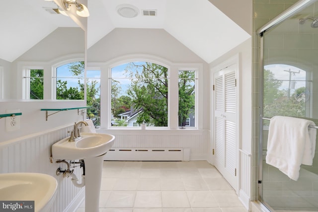 bathroom featuring visible vents, tile patterned flooring, a baseboard heating unit, a stall shower, and vaulted ceiling