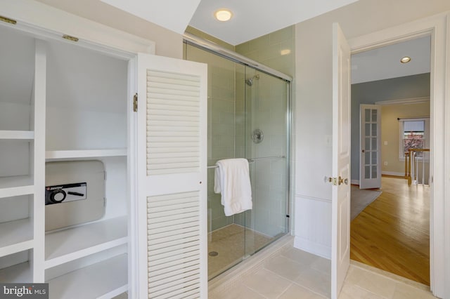 full bath featuring recessed lighting, tile patterned floors, and a shower stall