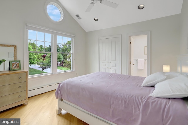bedroom featuring visible vents, vaulted ceiling, a baseboard heating unit, light wood-style floors, and recessed lighting