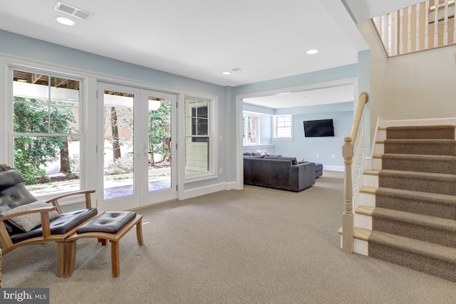 sitting room with visible vents, stairs, baseboards, french doors, and carpet