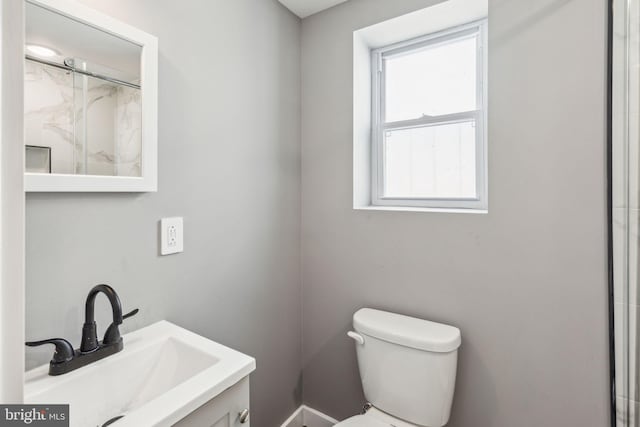 full bathroom with an enclosed shower, toilet, and vanity