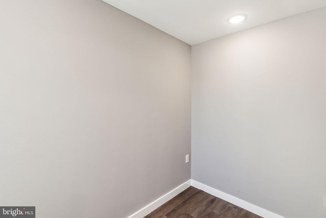 unfurnished room with baseboards, recessed lighting, and dark wood-style floors
