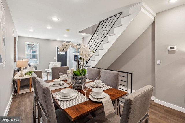 dining room featuring baseboards, recessed lighting, stairs, and wood finished floors