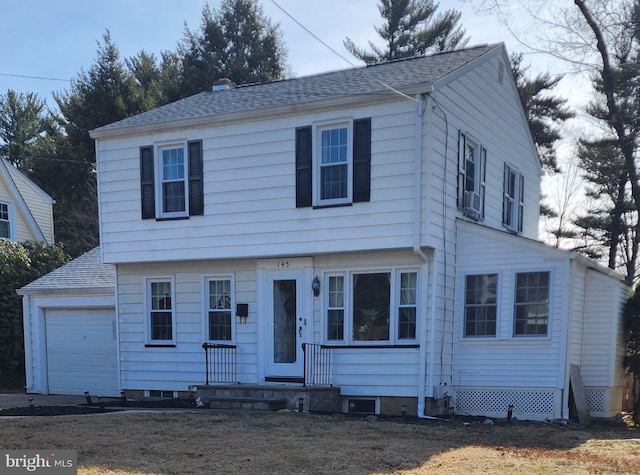 colonial house featuring a shingled roof