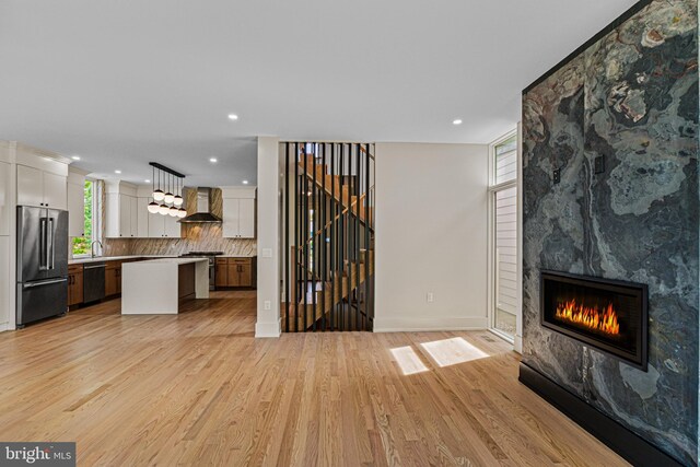 300 Ewing St, Princeton, NJ 08540 - unfurnished living room with light wood finished floors, a large fireplace, recessed lighting, baseboards, and stairs
