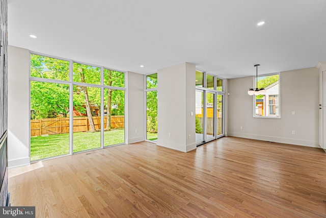 300 Ewing St, Princeton, NJ 08540 - unfurnished living room featuring baseboards, light wood-type flooring, a chandelier, recessed lighting, and floor to ceiling windows
