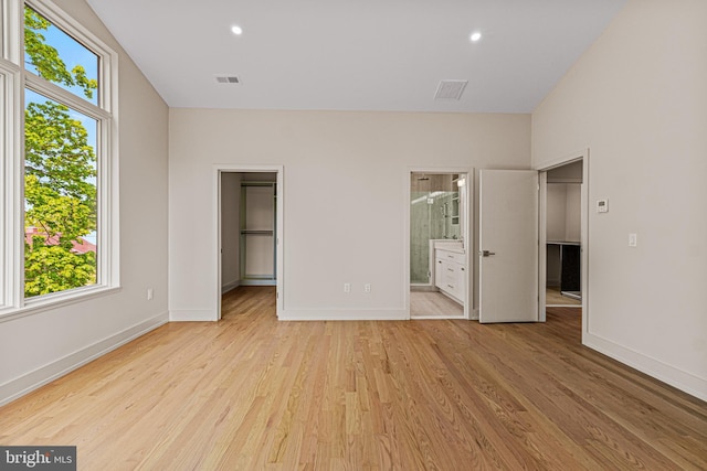 300 Ewing St, Princeton, NJ 08540 - unfurnished bedroom with a walk in closet, light wood finished floors, baseboards, a closet, and ensuite bath