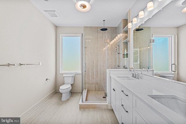 300 Ewing St, Princeton, NJ 08540 - bathroom featuring toilet, a stall shower, baseboards, double vanity, and wood finished floors