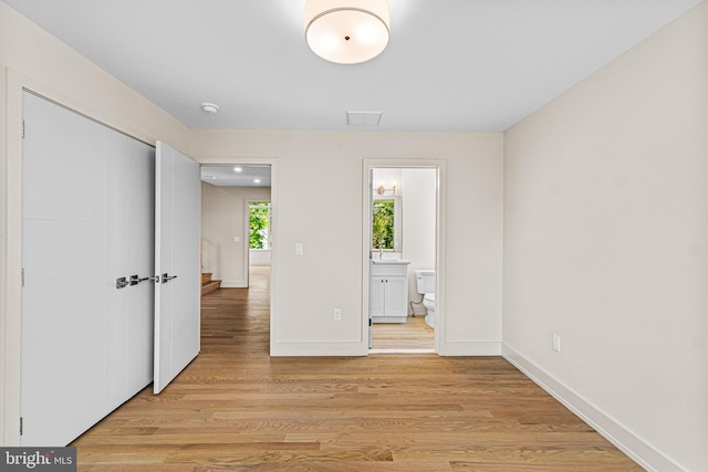 300 Ewing St, Princeton, NJ 08540 - unfurnished bedroom featuring light wood finished floors, connected bathroom, and baseboards