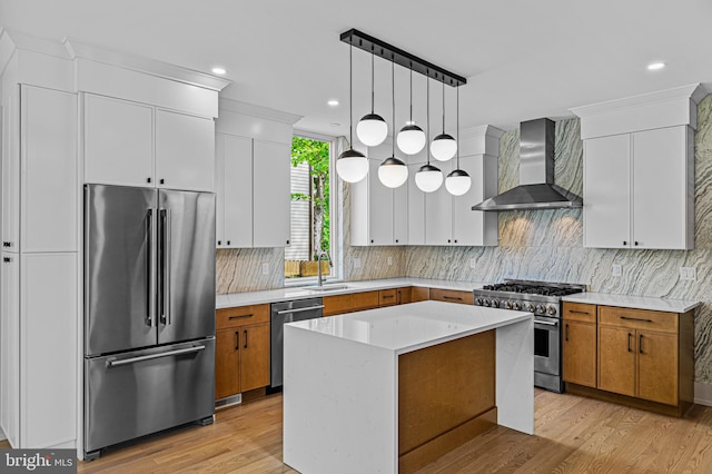 300 Ewing St, Princeton, NJ 08540 - kitchen with premium appliances, wall chimney exhaust hood, a sink, brown cabinetry, and recessed lighting