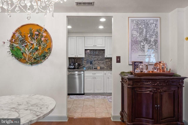 kitchen with white cabinetry, recessed lighting, backsplash, stainless steel dishwasher, and visible vents