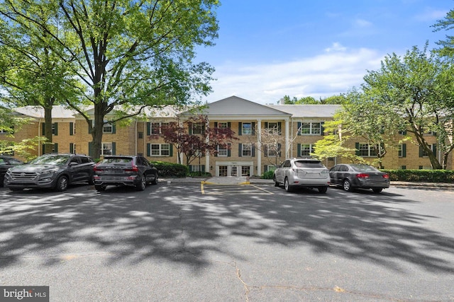 view of building exterior with uncovered parking