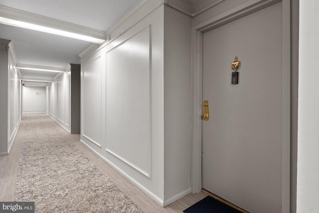 7651 Tremayne Pl Unit 207, Mclean, VA 22102 - hallway featuring baseboards, ornamental molding, and light wood-style flooring