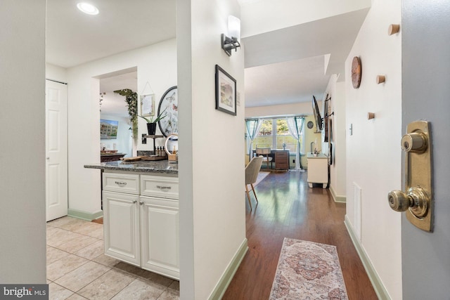 corridor with recessed lighting, baseboards, and light wood-type flooring